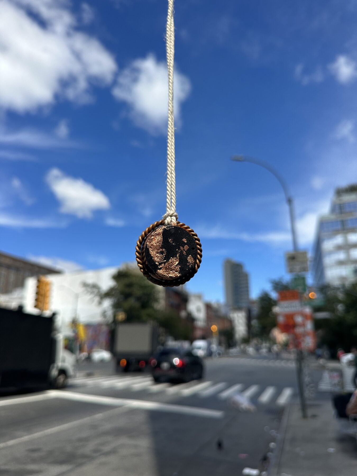 Halo Hanger pendant suspended outdoors against a city street