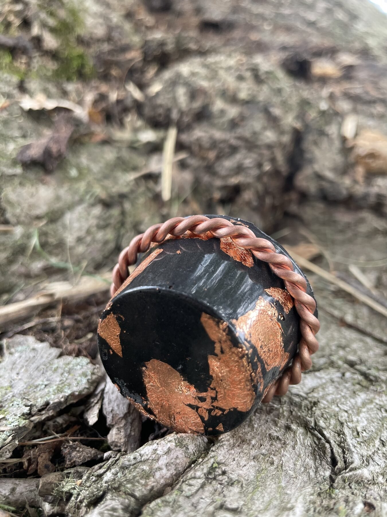 Black composite face with copper inclusions inside the Halo Hanger copper frame