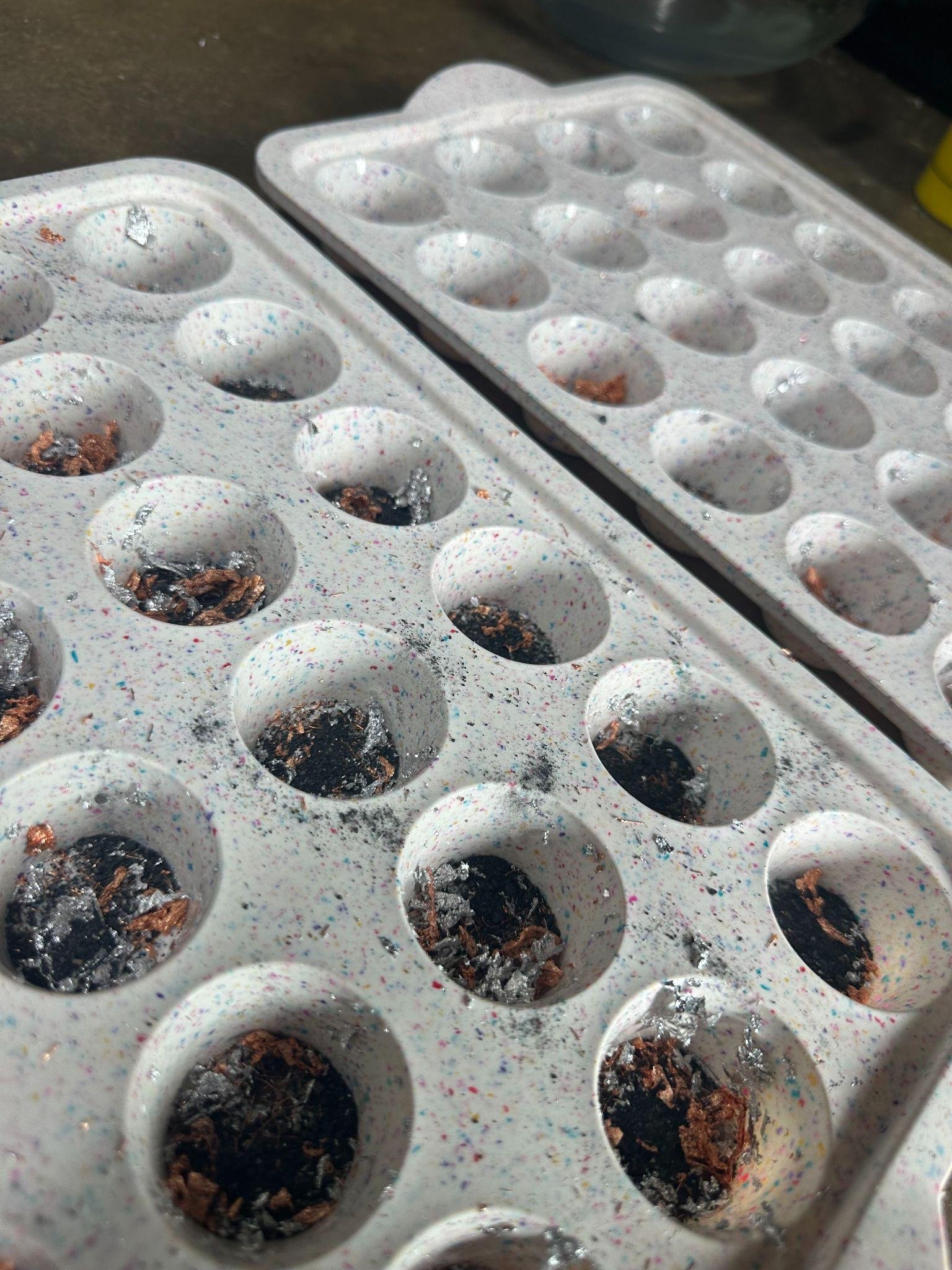 Authentic production image showing Peace Pucks in casting molds